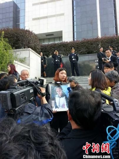 法院外，死者祁某的家人正在接受媒體采訪。 田雯 攝