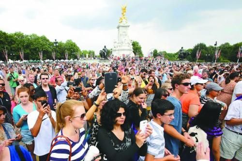 7月23日，在英國倫敦白金漢宮外，民眾們爭相閱讀“王室寶寶”出生的正式公告。