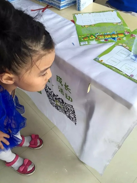 一只蝴蝶飛到小蝸牛的旗子上，小朋友看得入神啦~