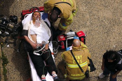 2日，救援人員在美國紐約地鐵事故車輛內(nèi)緊急疏散一名受傷乘客。圖/CFP
