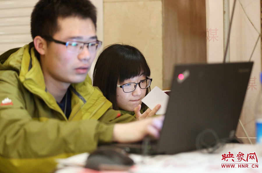 與同事現(xiàn)場(chǎng)寫稿子的樂(lè)天。